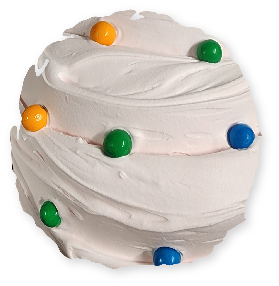 Swirled white frosting with colorful candies on top.