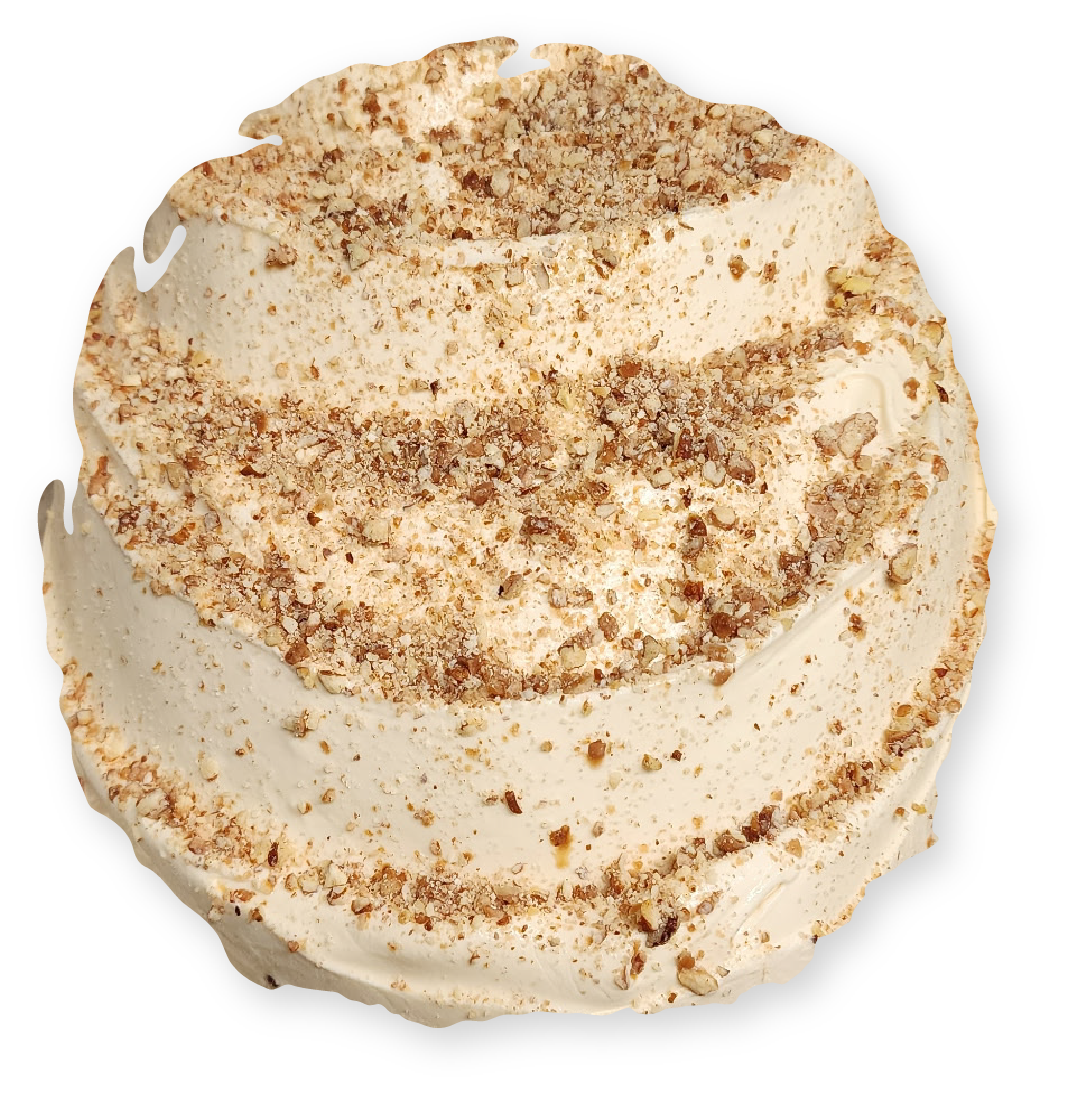 Swirled frosted dessert with crushed nuts on top.