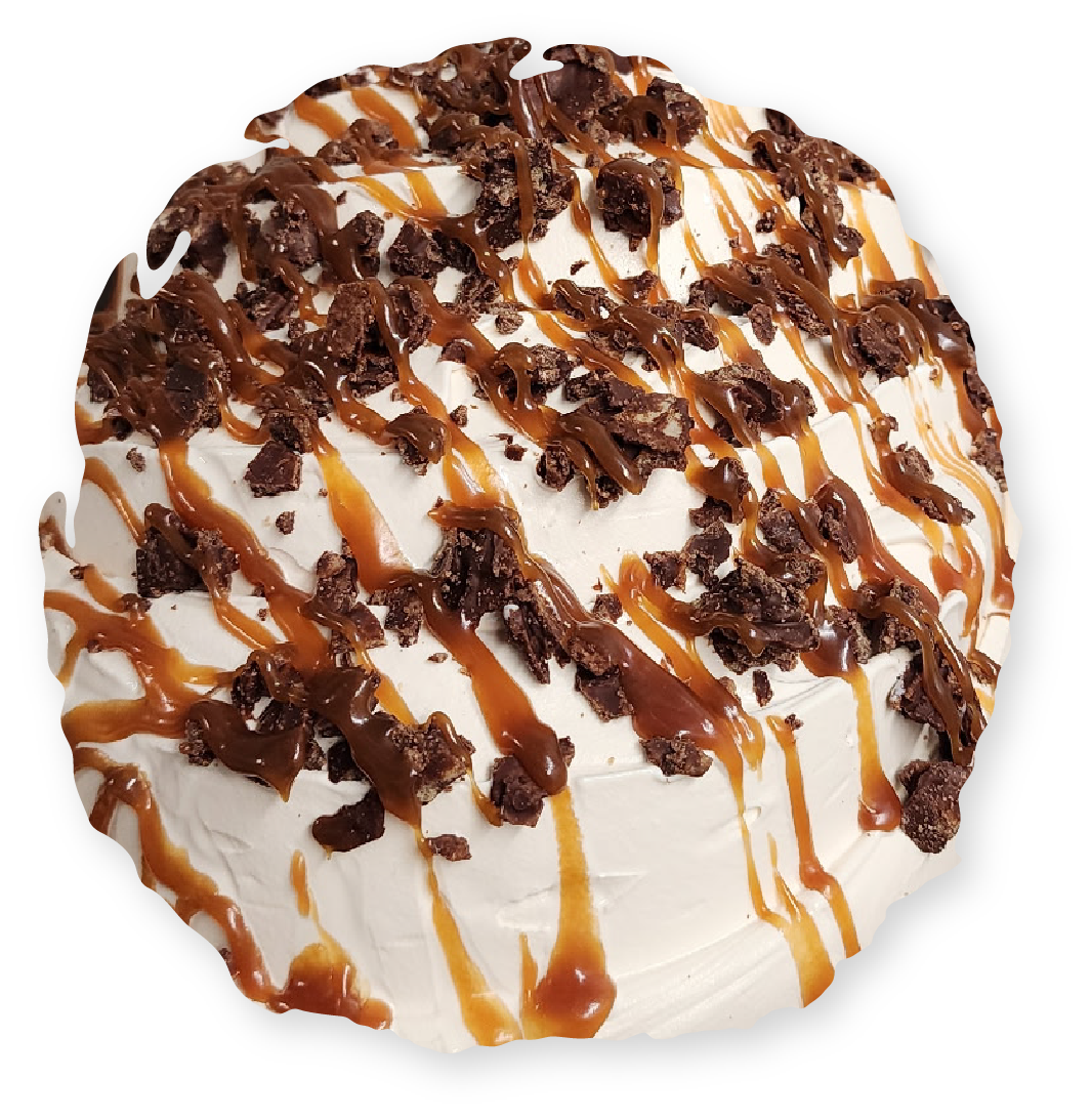 Cake topped with white frosting, caramel drizzle, and chocolate cookie crumbles.