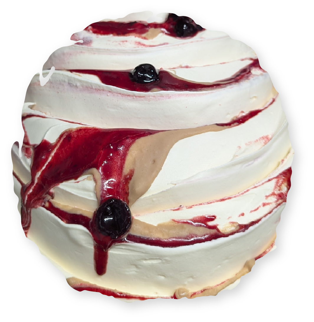 Pavlova dessert with white meringue and berry compote topping.