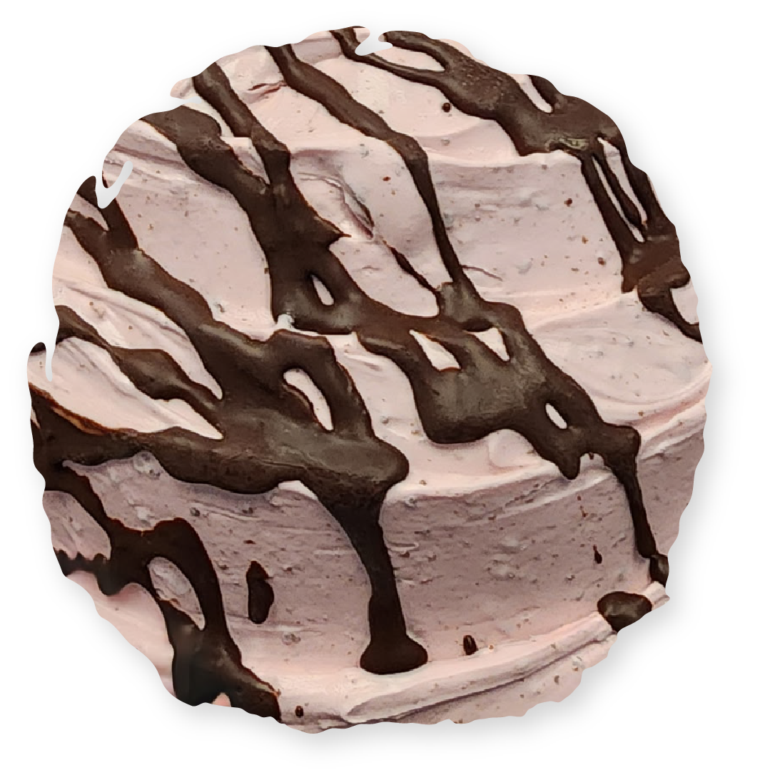 Pink frosted cake with chocolate drizzle.