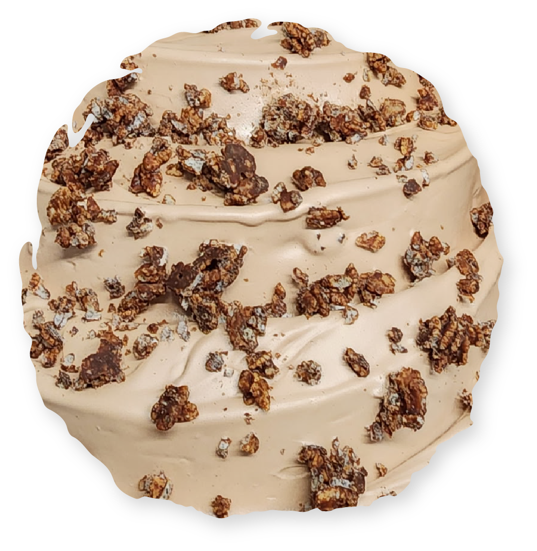 Cinnamon roll with tan frosting and chocolate crumble topping.