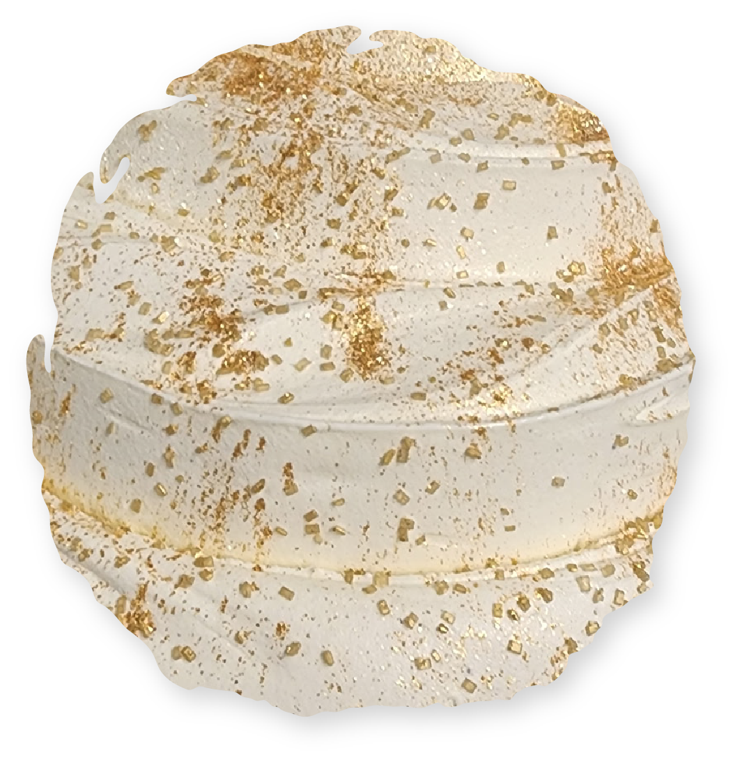 Cream-colored, round, tiered dessert topped with gold sprinkles and flakes.