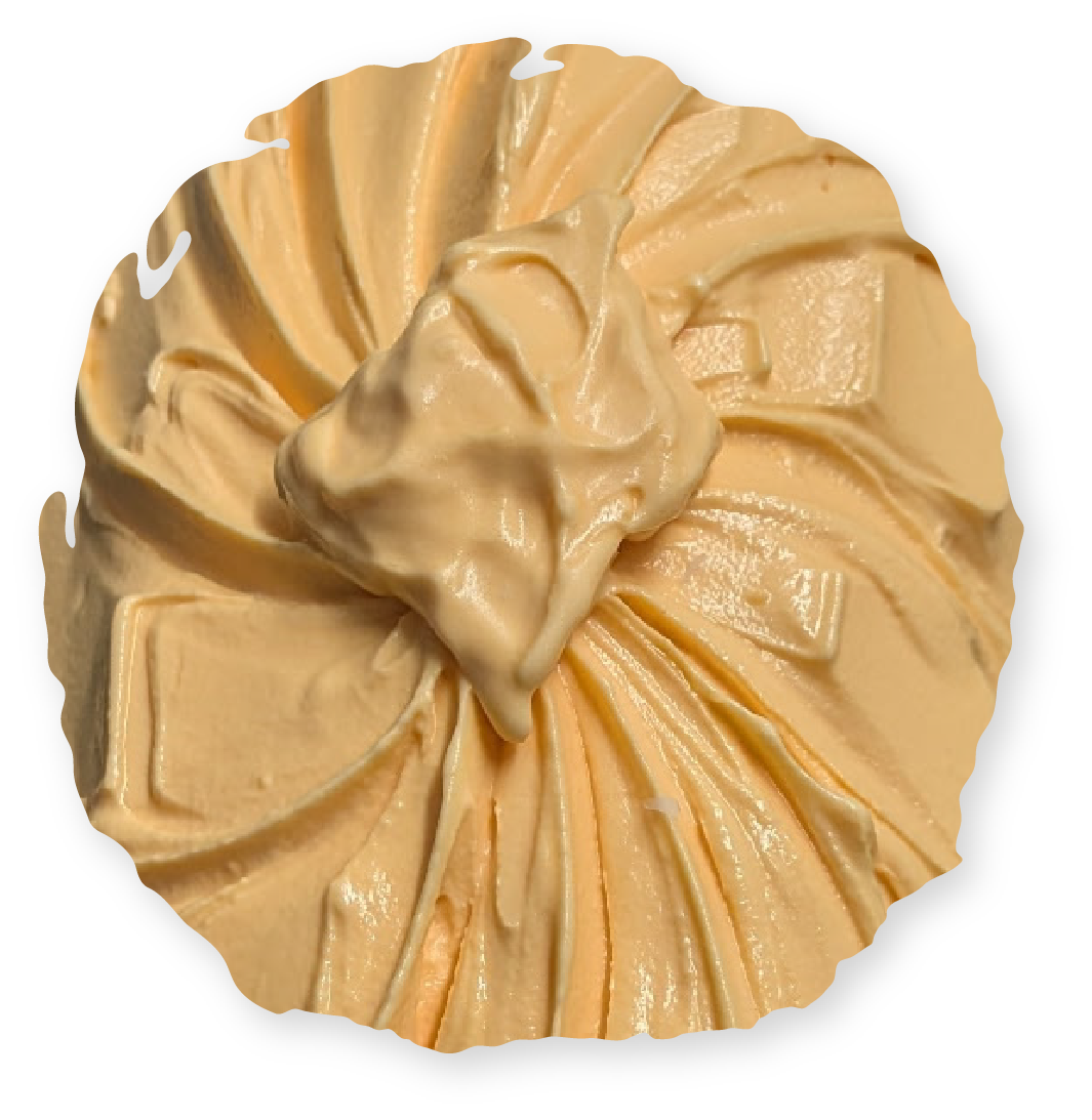 Swirled orange-colored frosting, with a dollop on top, like a pastry.
