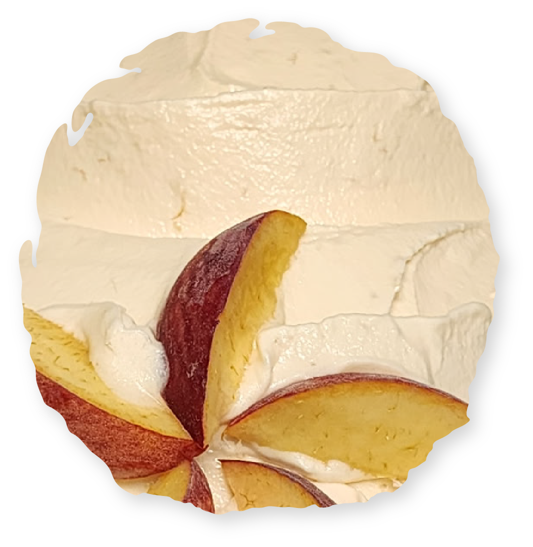 Whipped cream dessert with peach slices. Creamy, tan base with colorful fruit pieces.