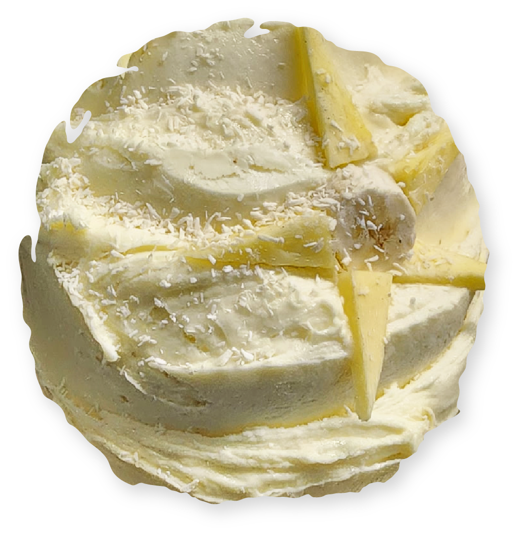 White layered cake with pineapple slices and shredded coconut.