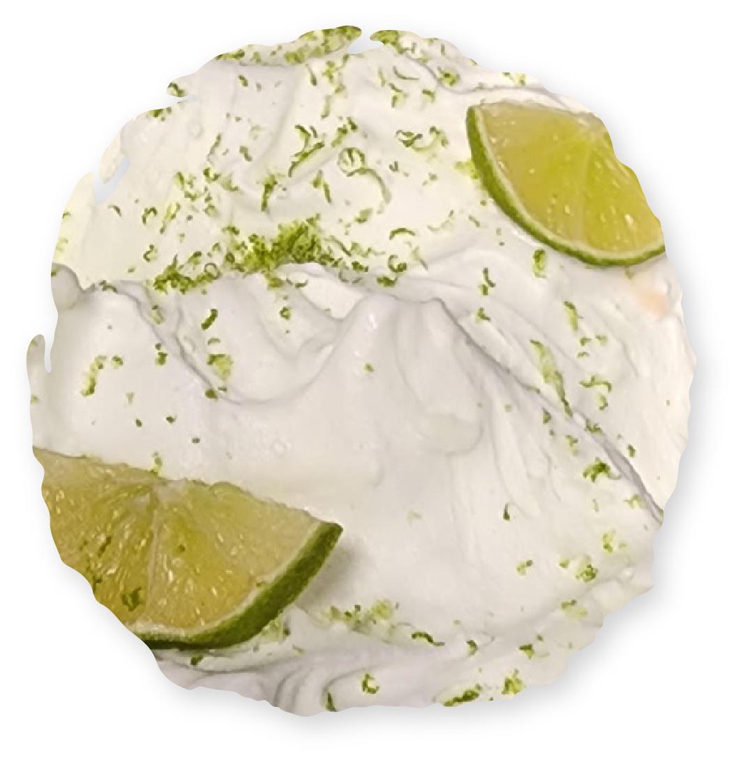Whipped cream dessert with lime slices and zest.
