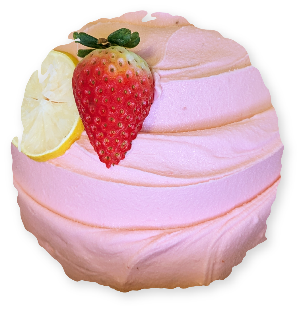 Pink frosted cupcake topped with a strawberry and lemon slice.