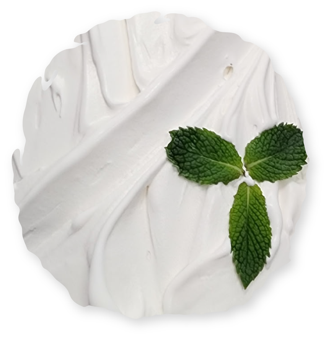 White whipped cream with three green mint leaves.