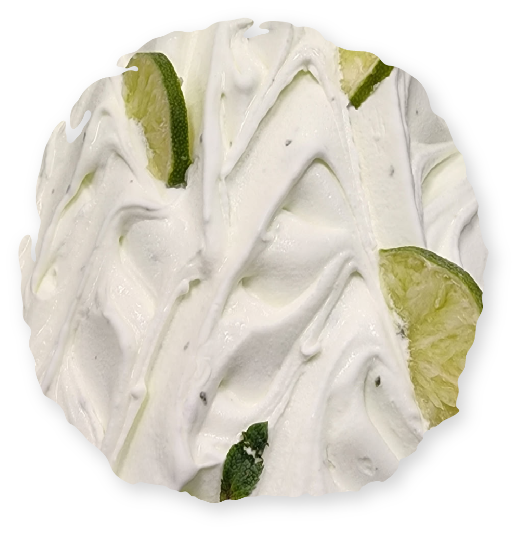Swirled white dessert with lime slices.