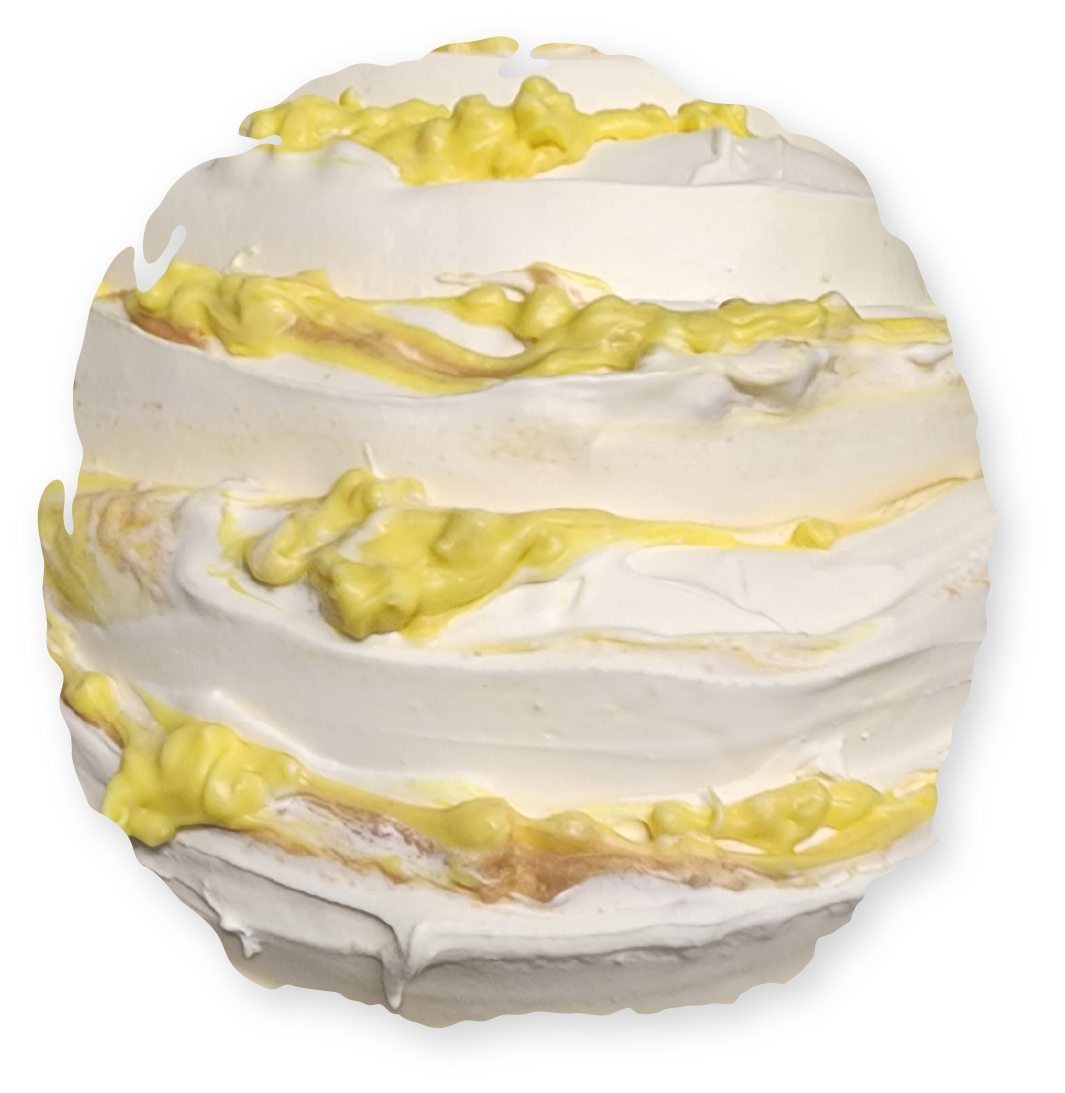White frosted dessert with yellow filling, round shape.
