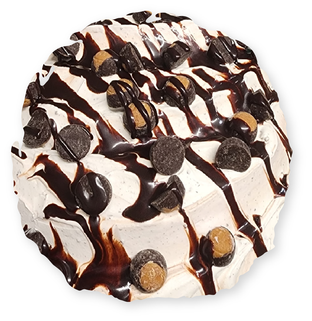 Cake topped with chocolate drizzle, candies, and frosting.
