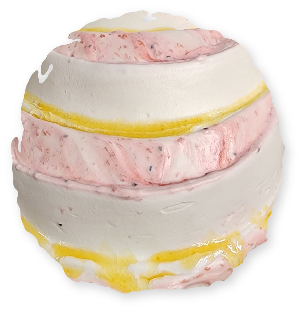 A layered bath bomb with white, pink, and yellow stripes.
