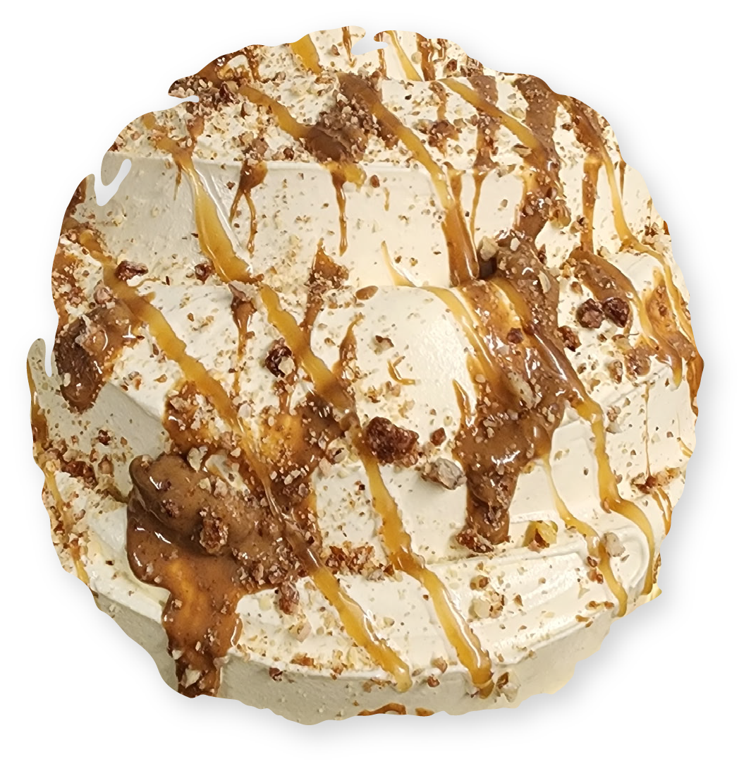 Cupcake with caramel drizzle, nuts, and frosting, overhead view.