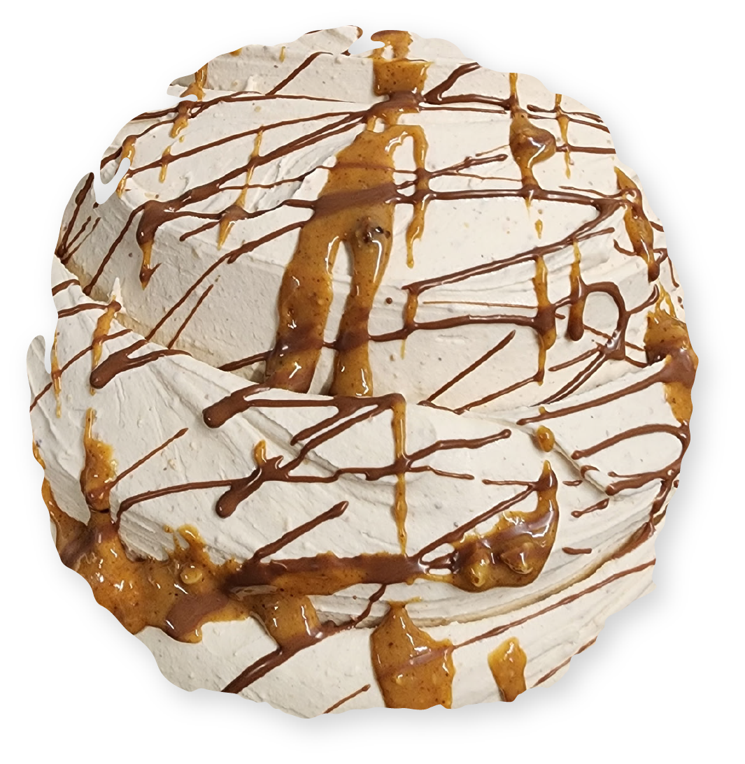 Whipped cream dessert with caramel and chocolate drizzle.