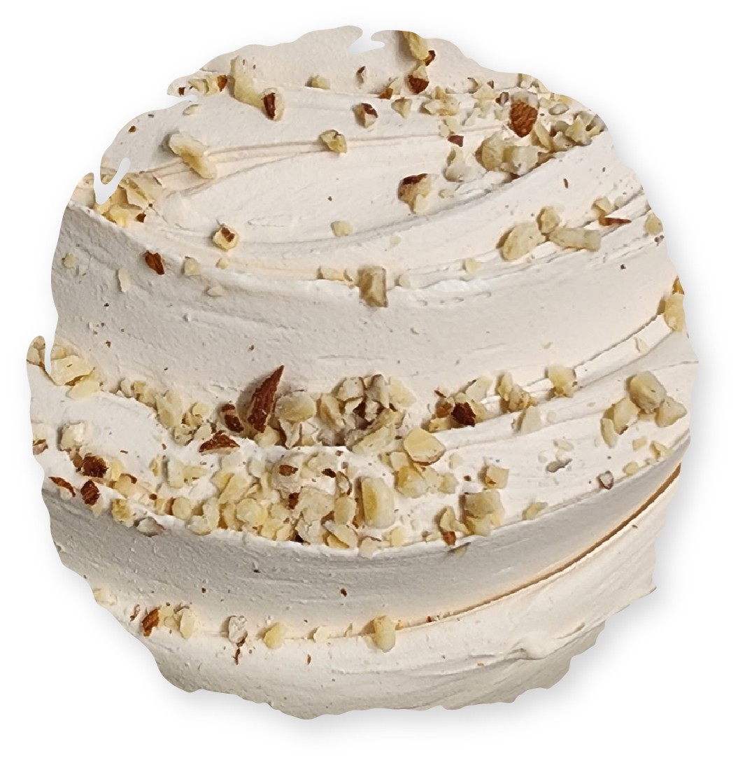 Swirled meringue dessert topped with chopped nuts.