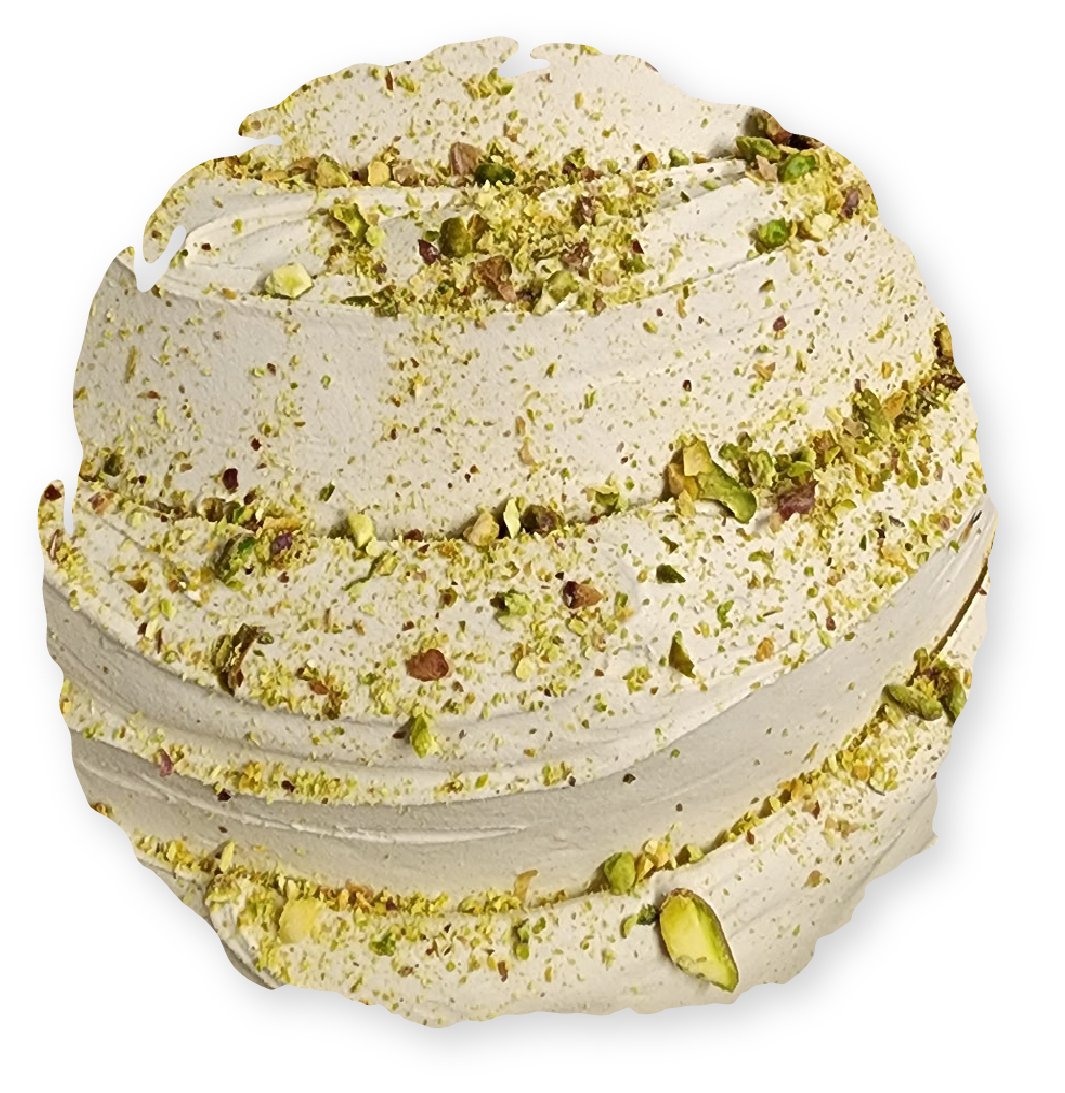 Scoop of pistachio gelato, light green, swirled layers, garnished with chopped pistachios.