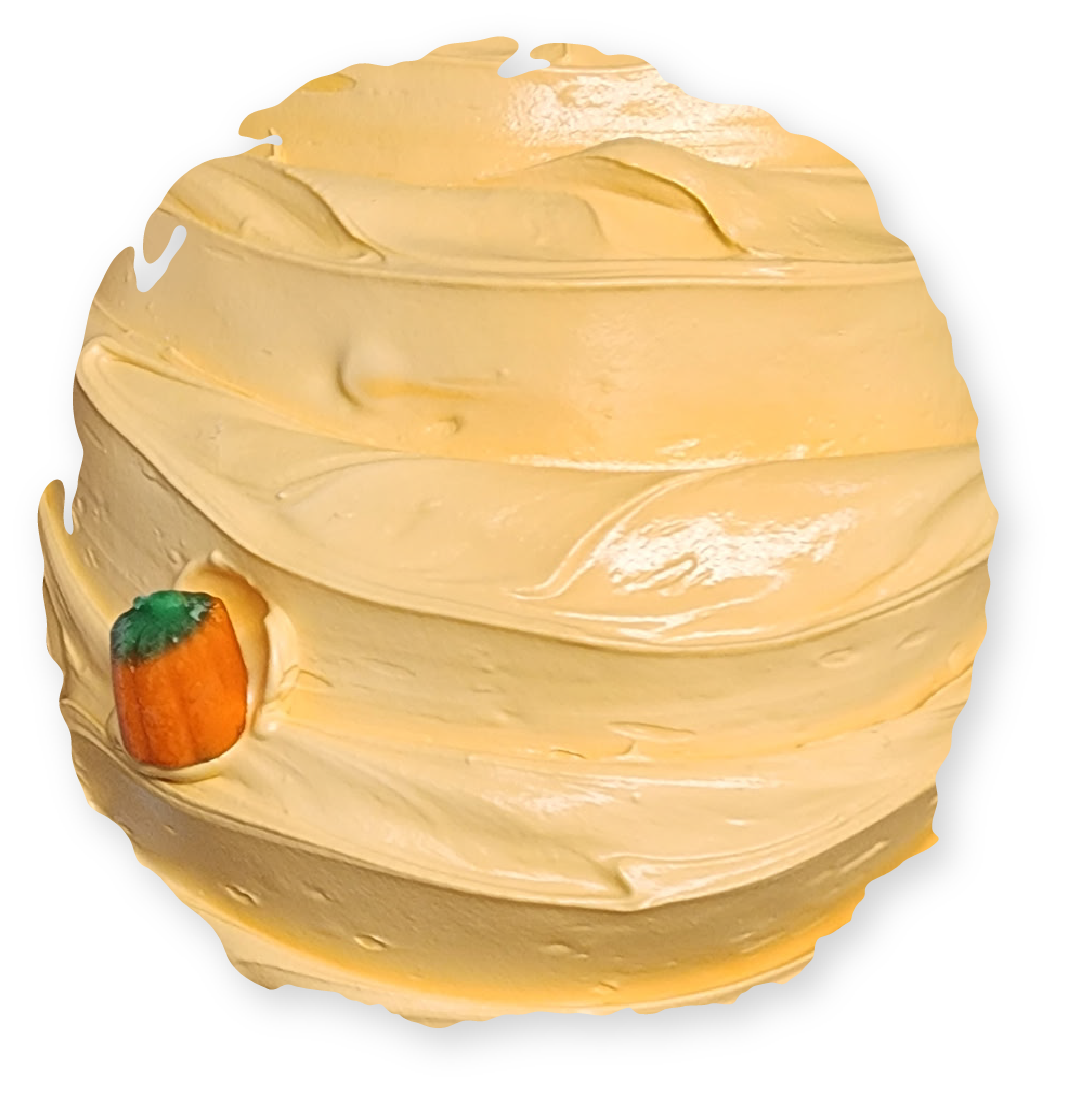 Yellow-layered, creamy confection with a pumpkin-shaped candy embedded in it.