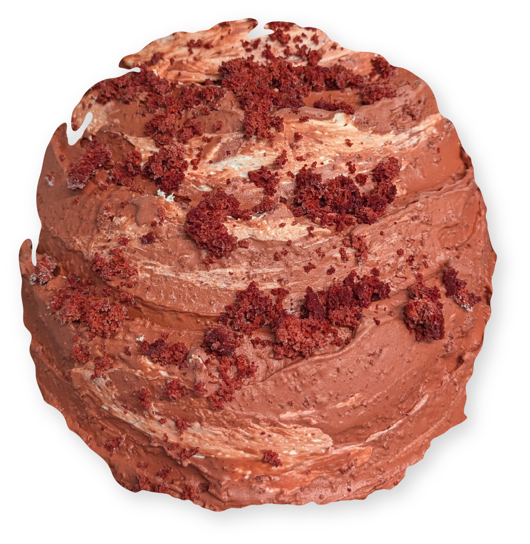 Red velvet cupcake, swirled frosting, red cake crumbles.