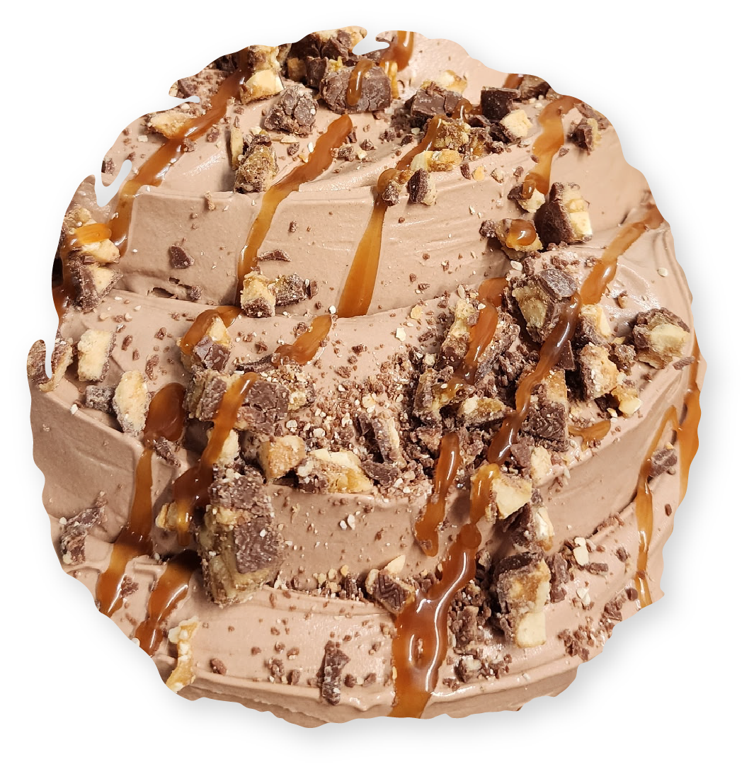 Chocolate ice cream with caramel drizzle and candy pieces.