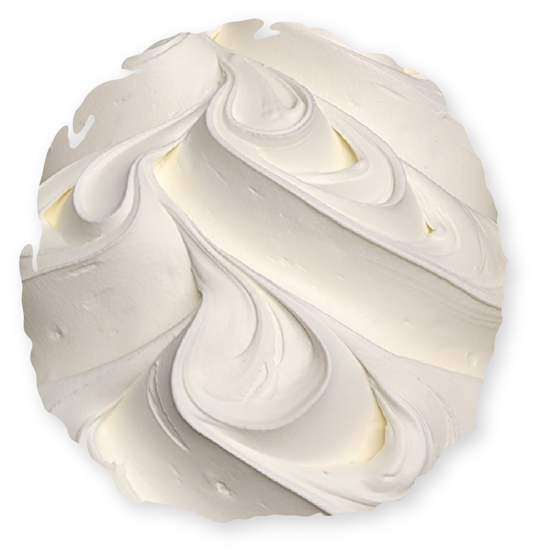 Swirled white frosting, possibly buttercream, on a circular surface.