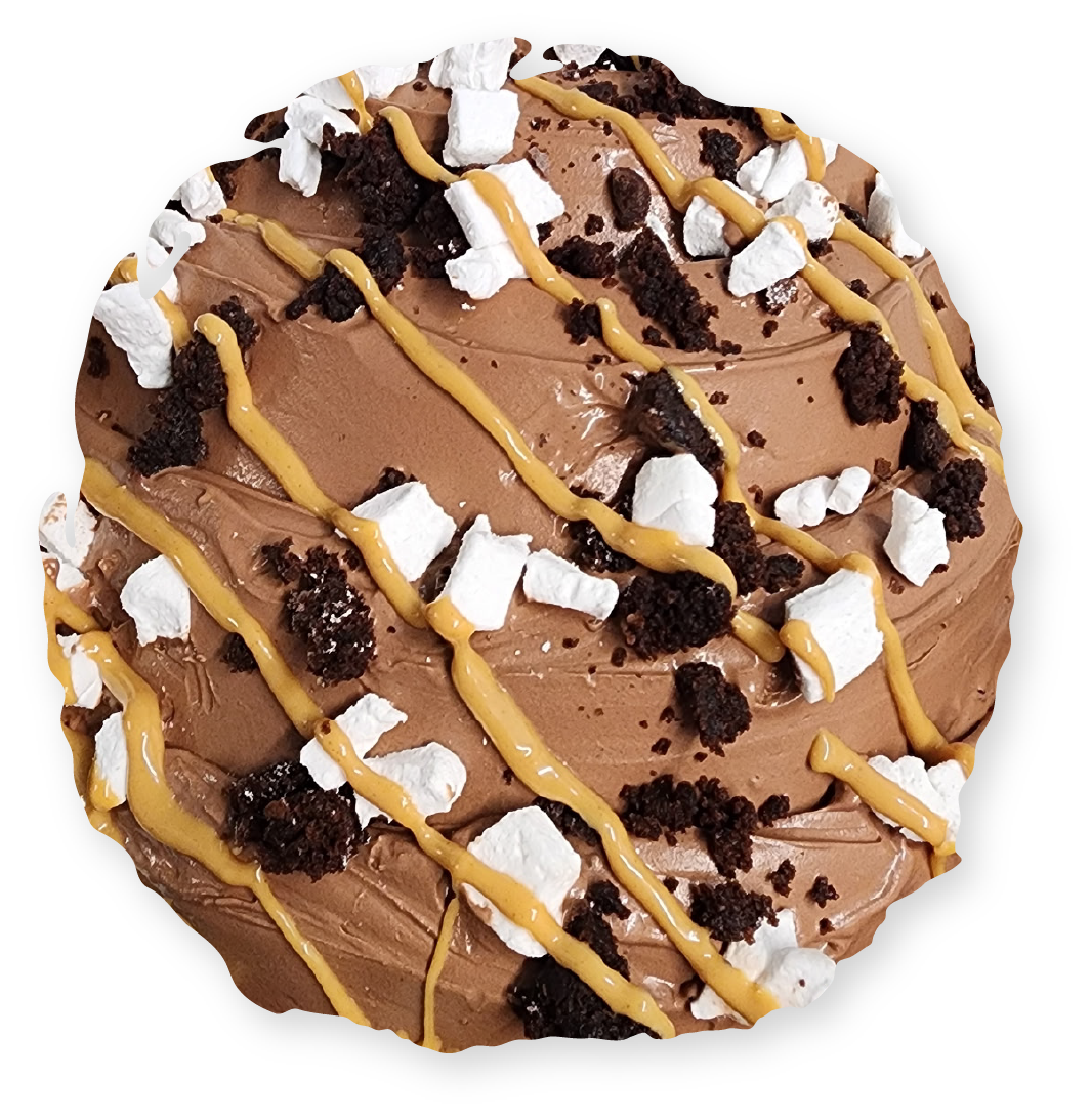 Chocolate frosted dessert with peanut butter drizzle, marshmallows and brownie crumbles.