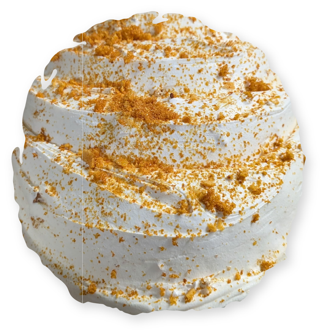 Swirled white frosting topped with golden crumbs.