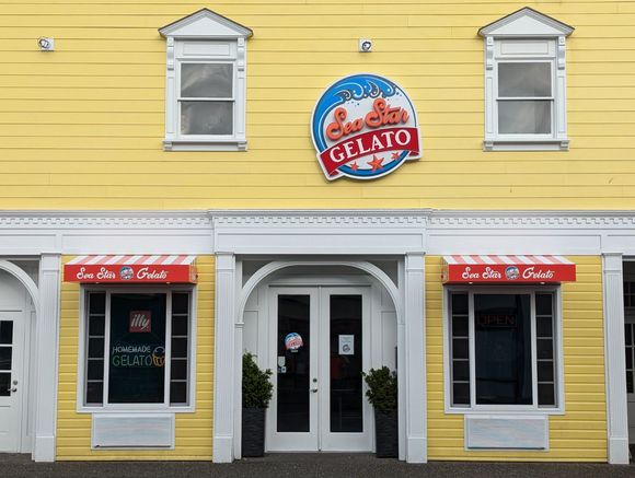 A yellow building with a sign that says Sea Star Gelato on it