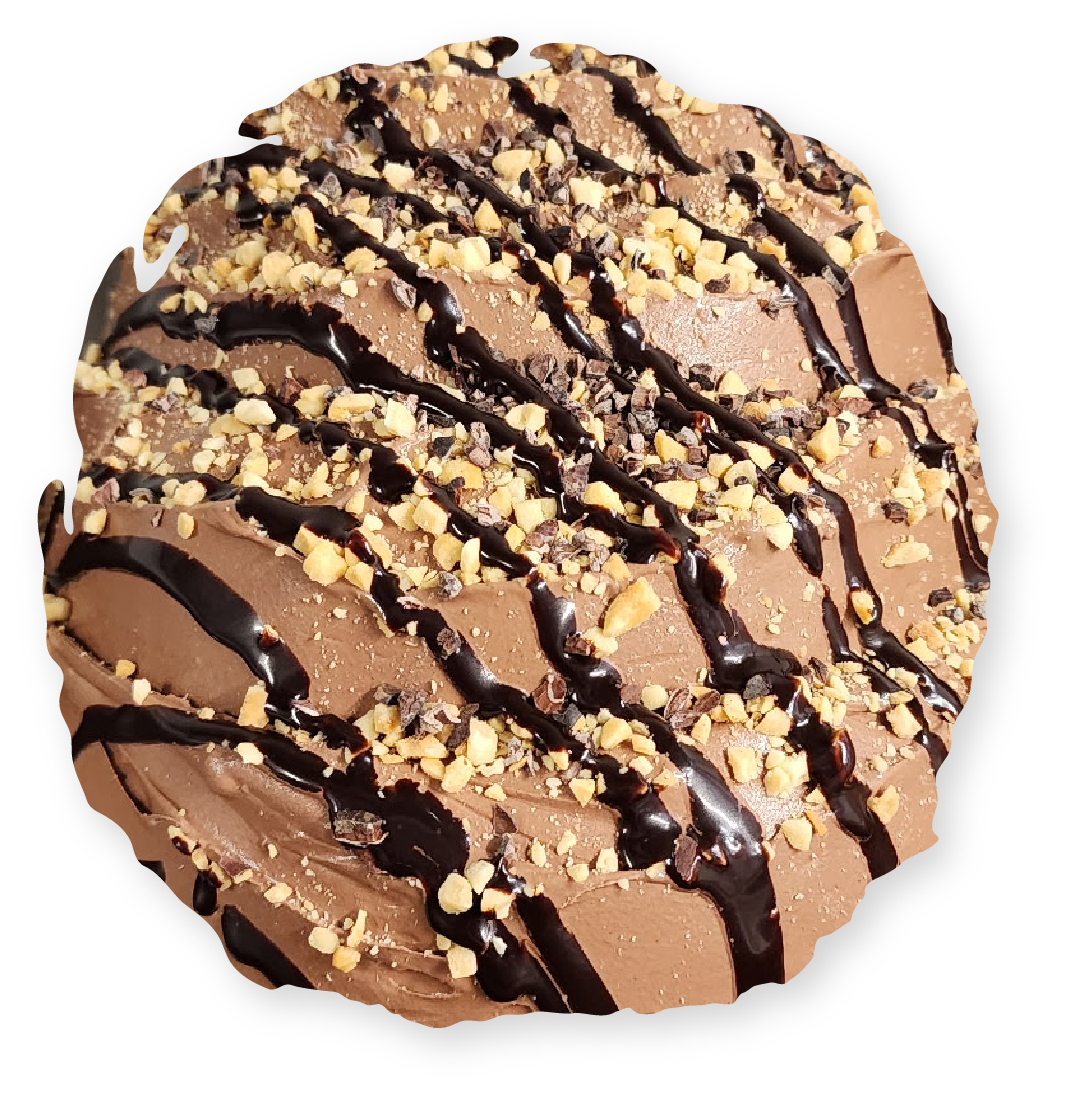 Chocolate cookie with chocolate drizzle and chopped nuts.