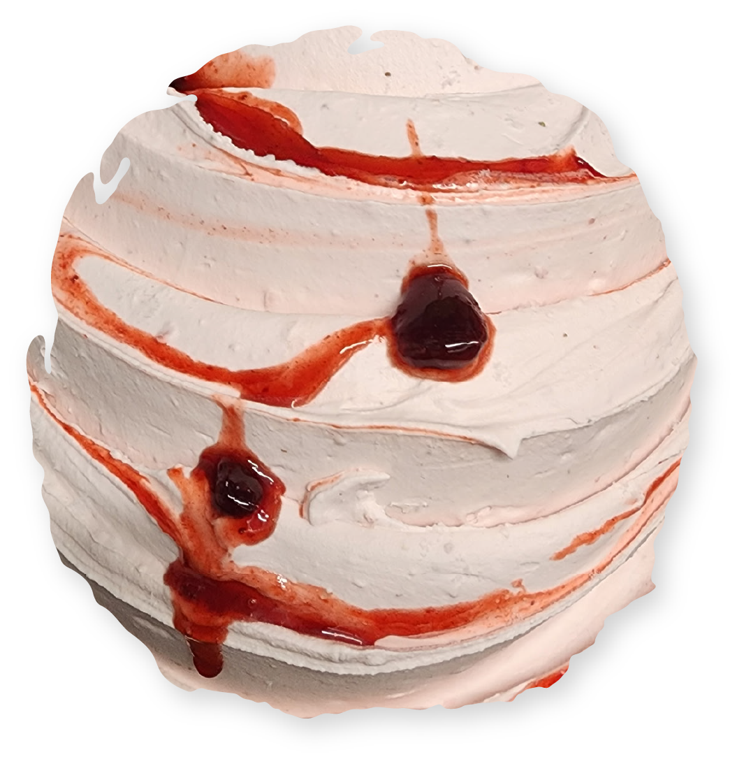 Whipped dessert with red fruit sauce drizzled over it.