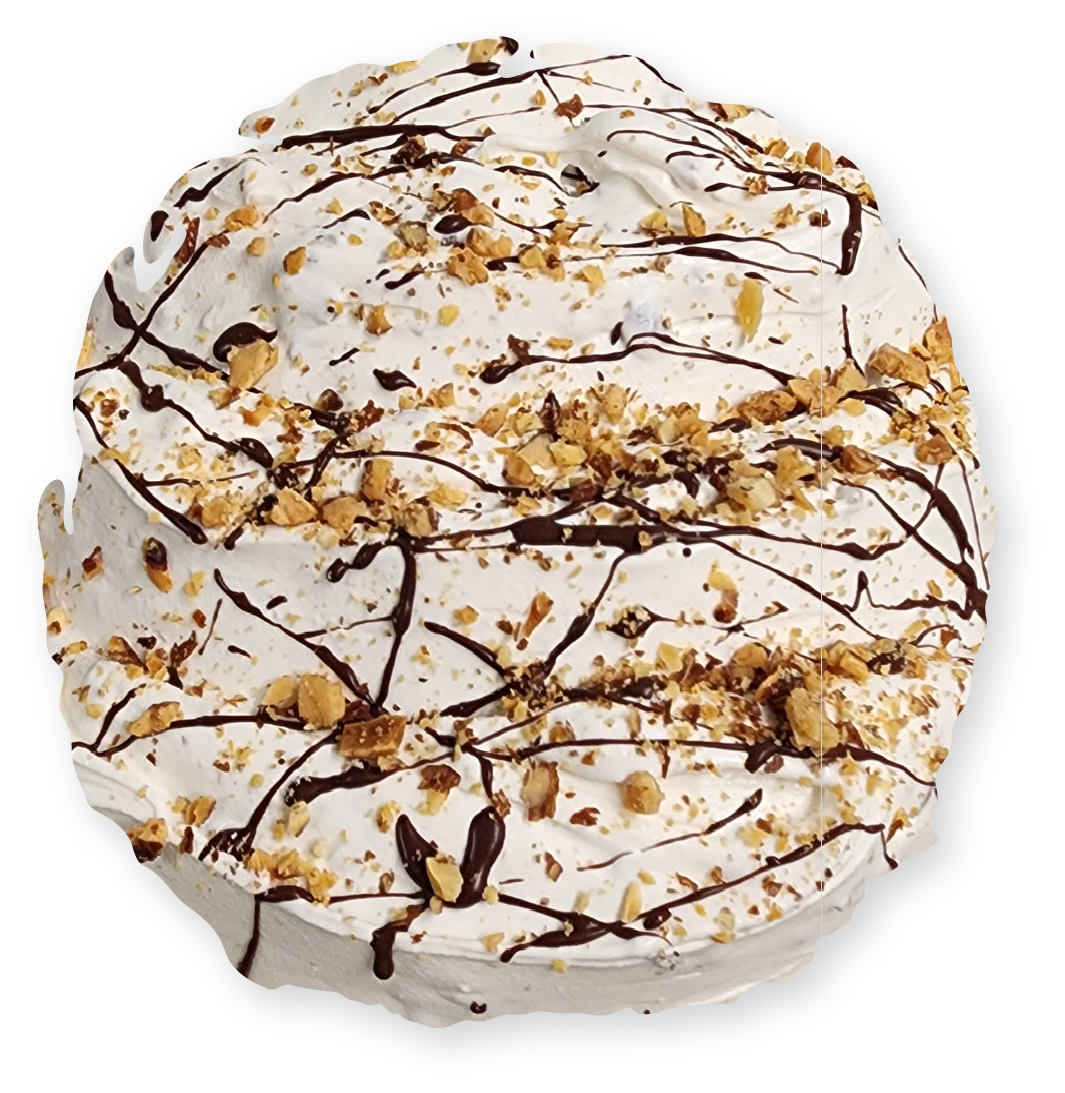 Whipped cream dessert with chocolate drizzle and chopped nuts.