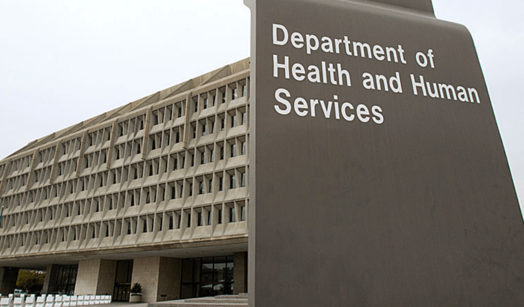 A department of health and human services sign in front of a building