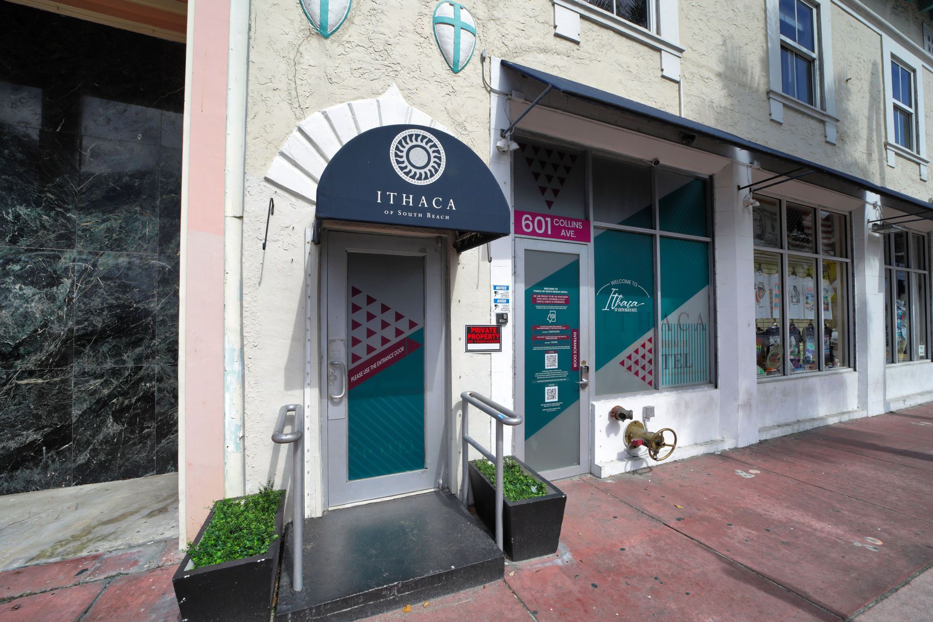Exterior of a business with a teal and red color scheme, awning, and door.