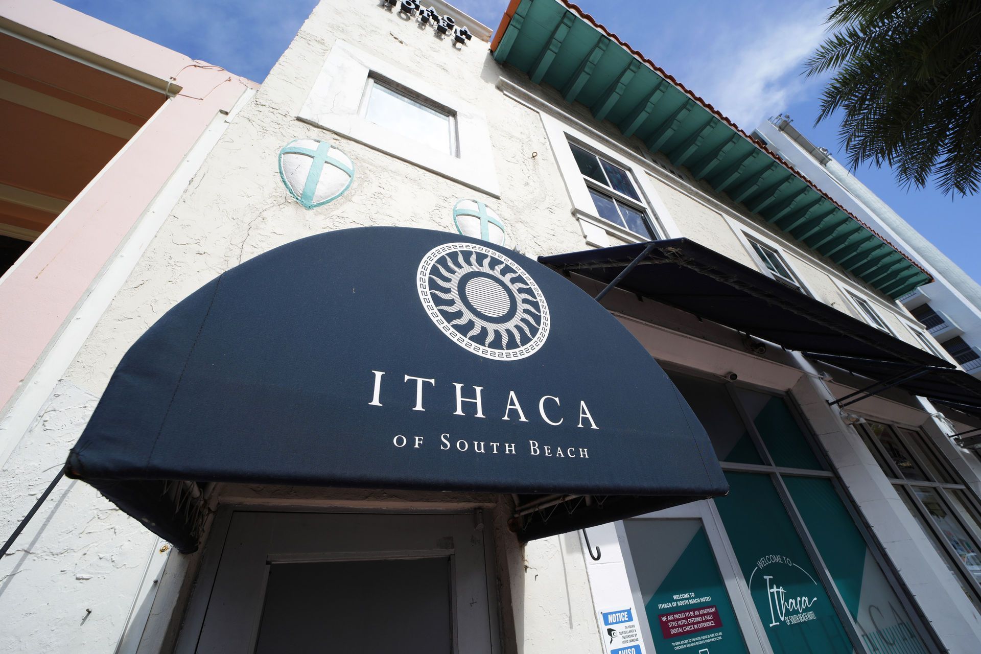 Ithaca on South Beach restaurant exterior with dark blue awning and logo.