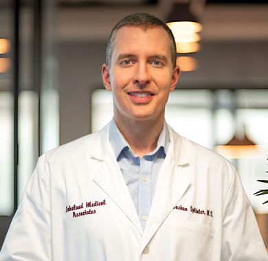 Portrait of a smiling doctor in a white lab coat in a bright office setting