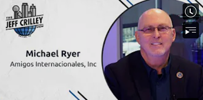 Michael Ryer, Amigos Internacionales, Inc. on The Jeff Crilley Show, wearing glasses, in a studio setting.