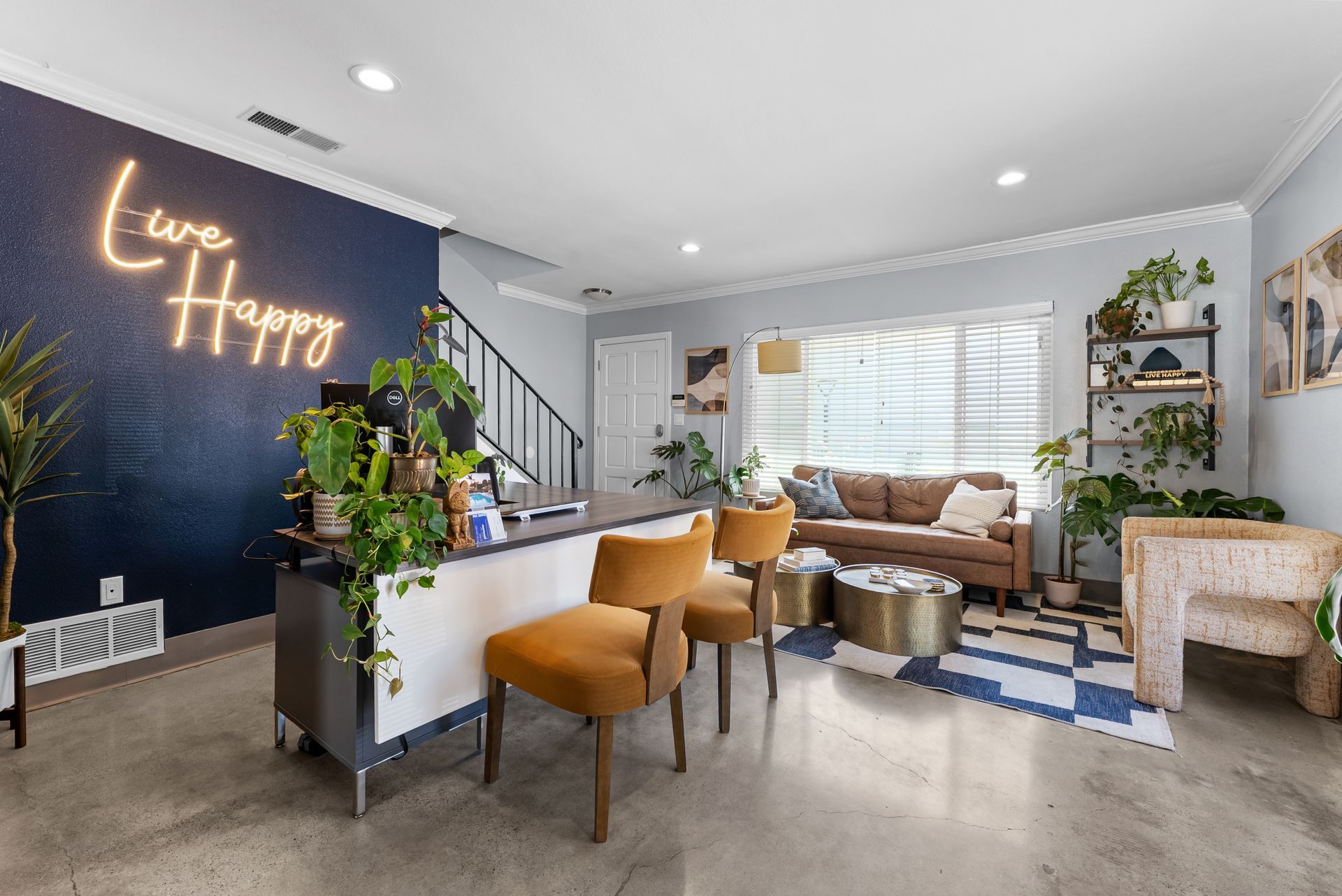 office with couch, desk, chairs, and Live Happy sign