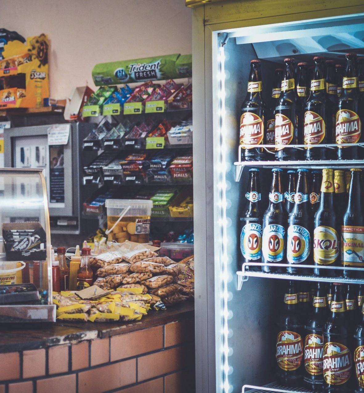 An expansive commercial chiller brimming with a variety of refreshing beverages, including sodas, juices, bottled water, and energy drinks.