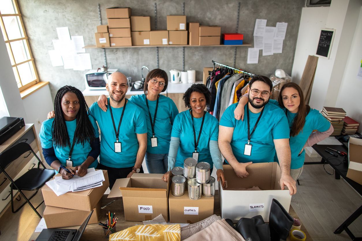 Community interest company team sorting donations and supplies in a social enterprise workspace