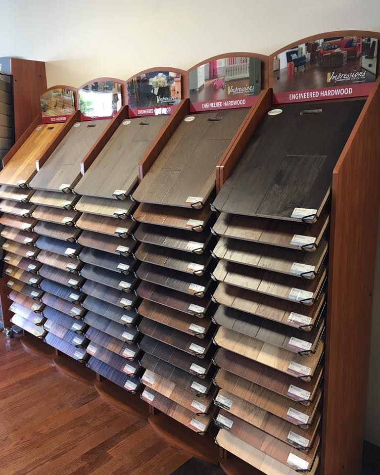 Display of various wood flooring samples in a showroom, showcasing colors and textures.