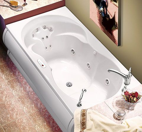 A bathtub in a bathroom with a picture on the wall above it