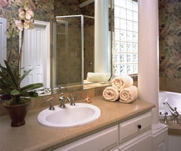 A bathroom with a sink , mirror , and tub.