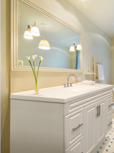 A bathroom with a sink and a large mirror