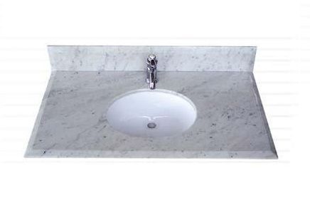 A bathroom sink with a faucet on a white counter top.