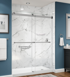 A bathroom with marble walls and a sliding glass shower door