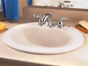 A bathroom sink is sitting on a counter next to a bathtub.