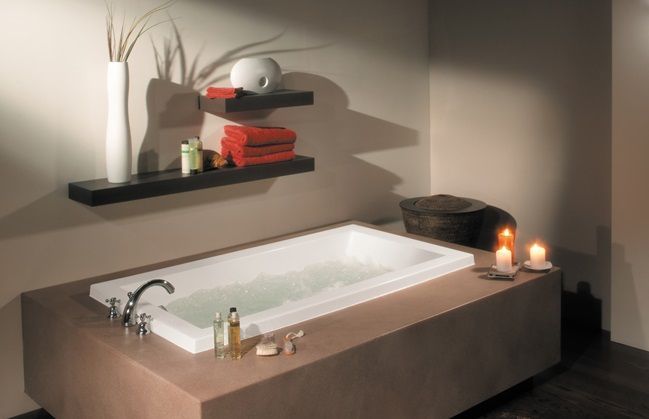 A bathroom with a bathtub and candles on the counter