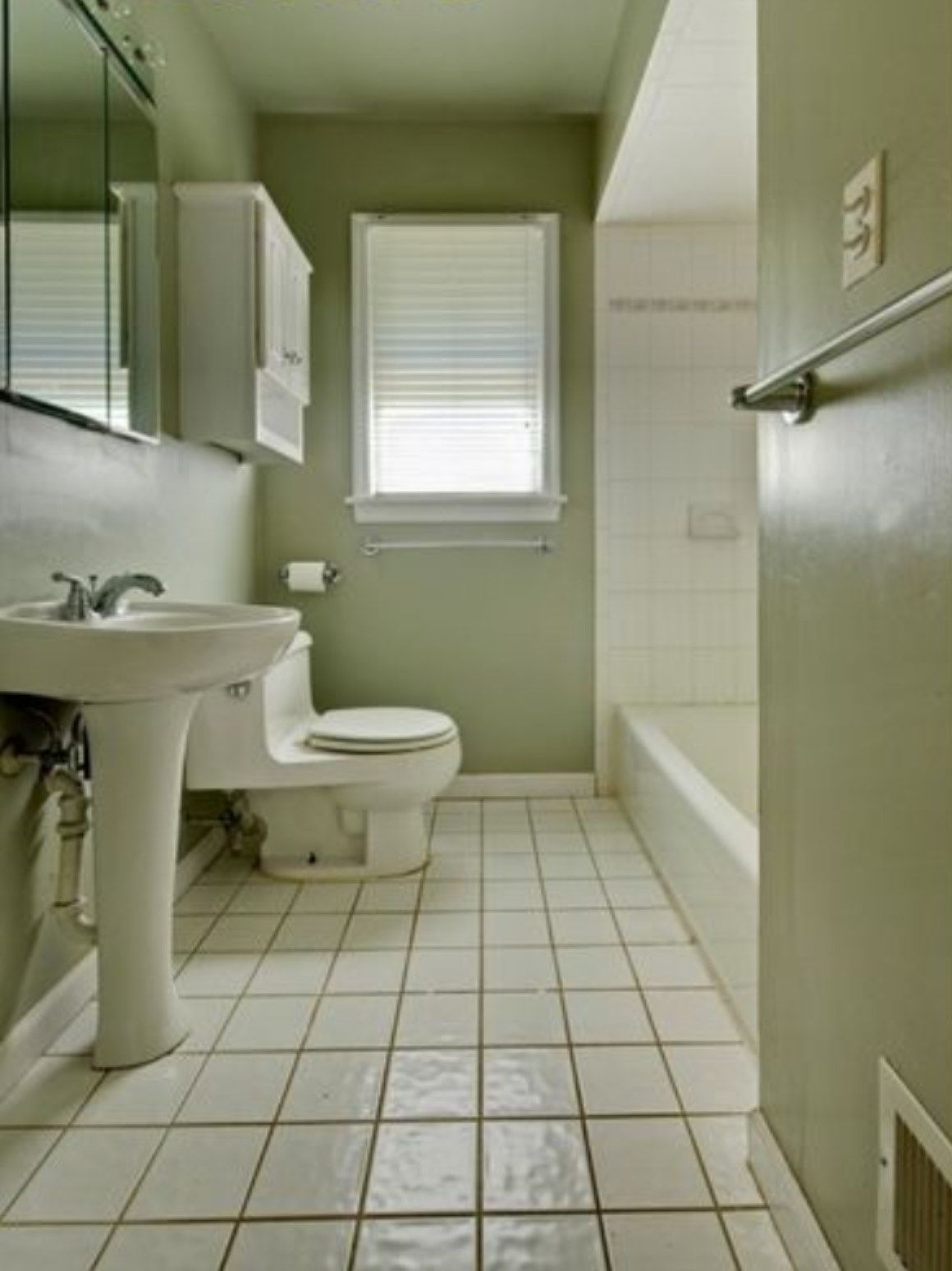 A bathroom with a toilet a sink and a bathtub