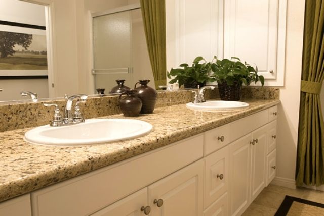 A bathroom with two sinks and a large mirror