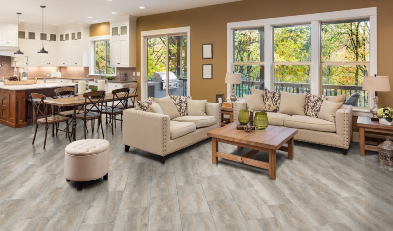A living room filled with furniture and a dining room.